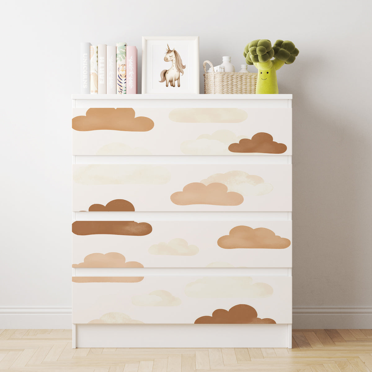 Vit IKEA MALM-byrå med fyra lådor och dekorfolie med moln i beige, bruna och ljusa naturtoner.